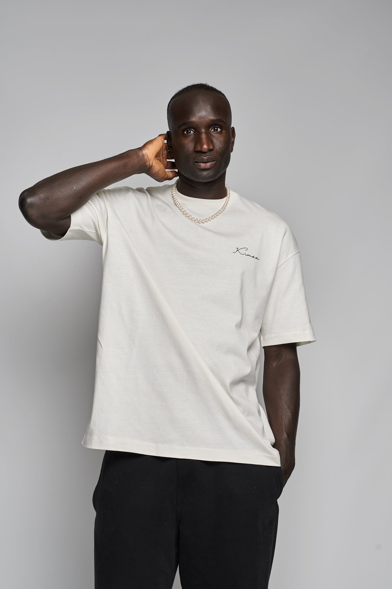 Model wearing Bankoo beige organic cotton T-shirt from the front — relaxed fit Afro-Nordic streetwear by Kimaa.