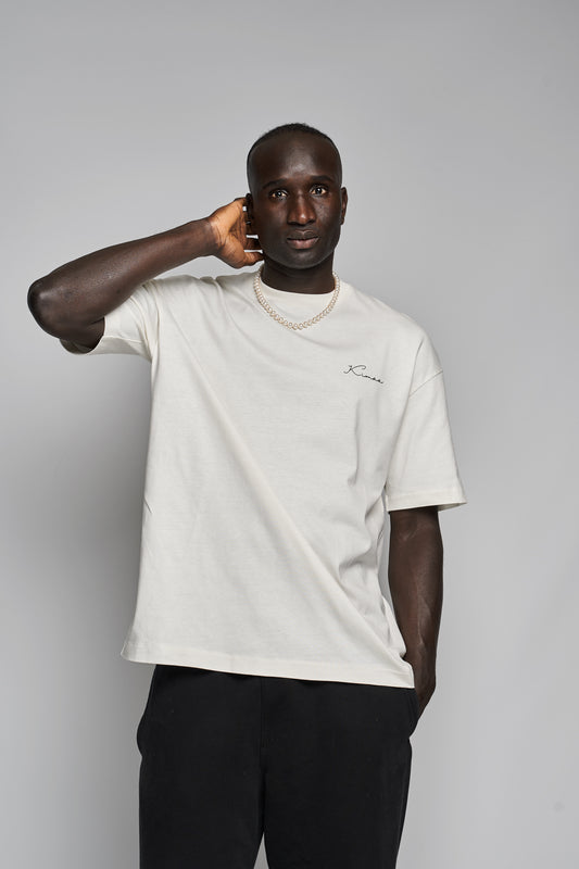 Model wearing Bankoo beige organic cotton T-shirt from the front — relaxed fit Afro-Nordic streetwear by Kimaa.