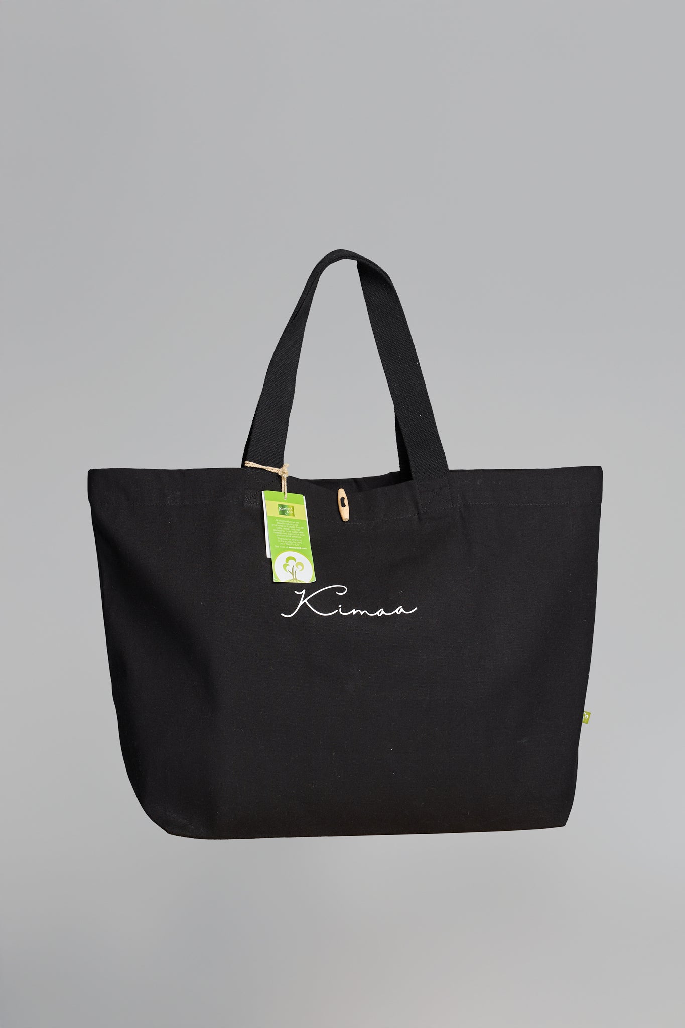 Full view of Maabo black organic cotton tote bag with wooden toggle and Kimaa logo