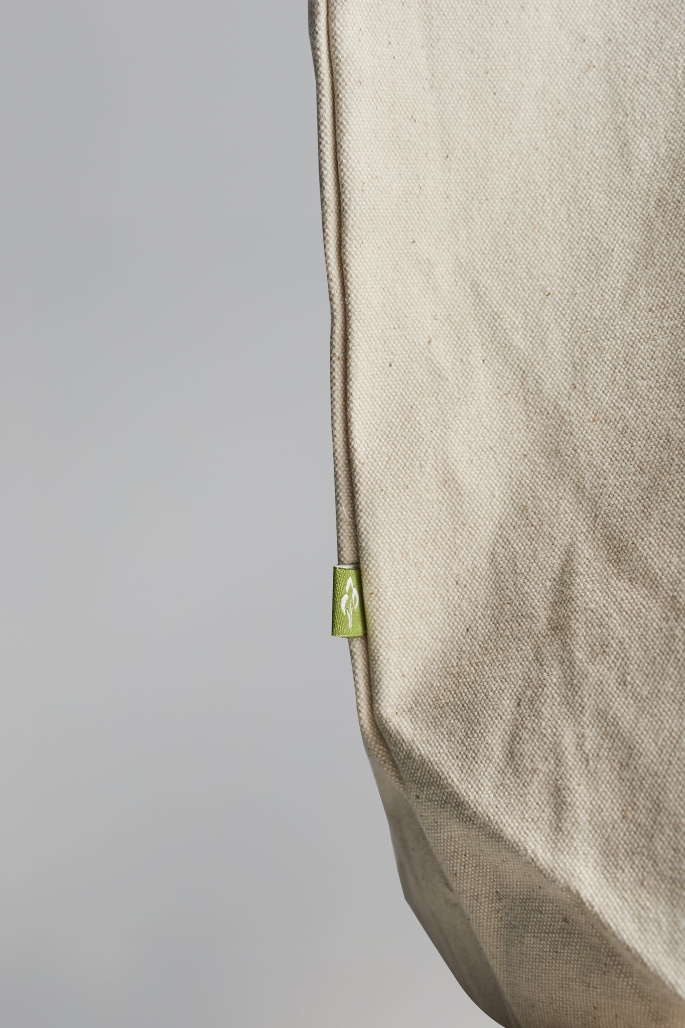 Closeup of small tree logo on the side of Kimaa’s Taamoo tote bag, highlighting eco-conscious branding.